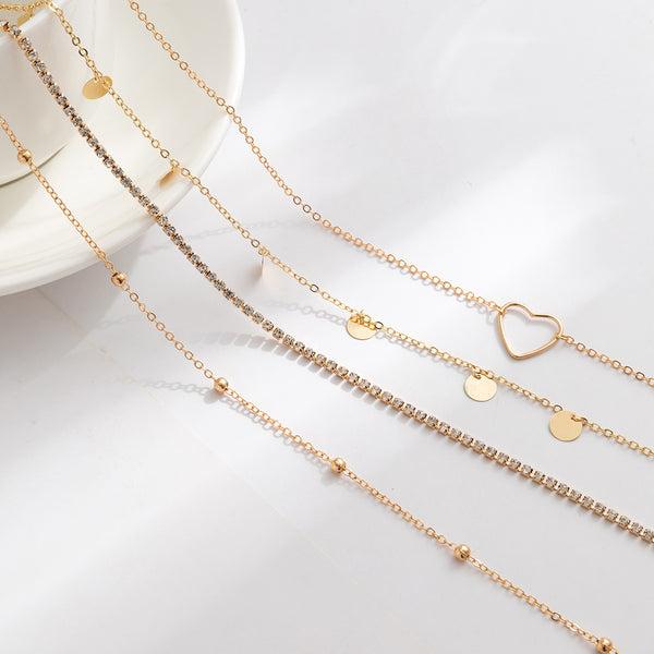 Ensemble de 4 chaînes de taille cœur et zircon. Argenté et dorée