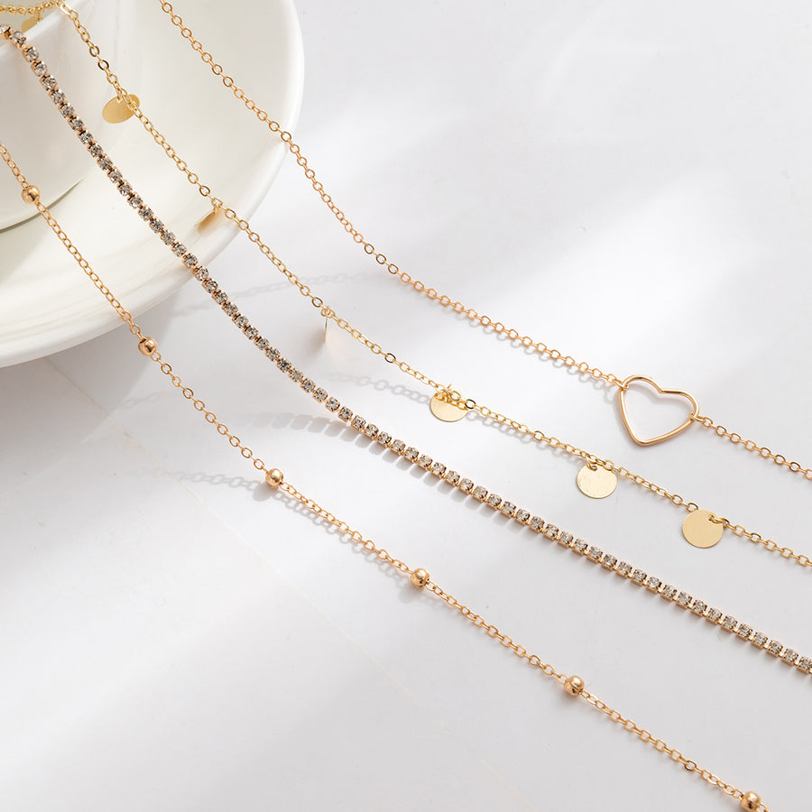 Ensemble de 4 chaînes de taille cœur et zircon. Argenté  et dorée