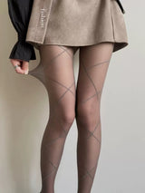 Lot de quatre collants clair ornés d’un délicat motif