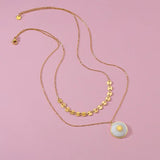 Collier en acier inoxydable duo sertis  de pierres de nacres  blanches.
