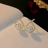 Boucle d'oreille perle d'eau douce X