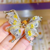 Broche papillon en zircon champagne