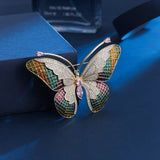 Broche papillon en zircon rose et émail